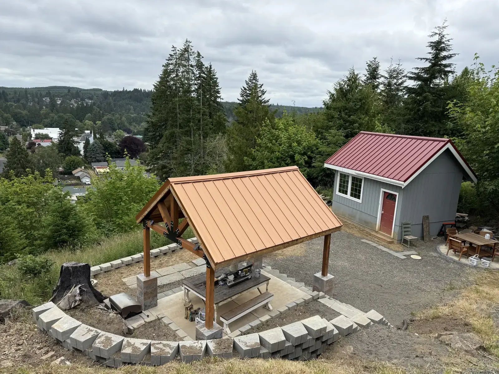 The same hillside finished, with a pavilion, block terrace walls and the tiny house